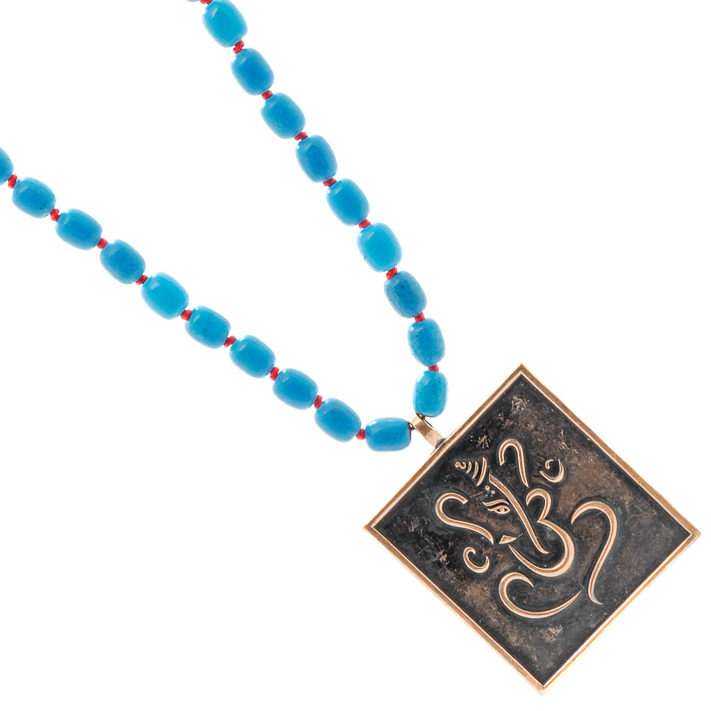 Turquoise necklace adorned with a Ganesha and Buddha pendant, radiating positive vibes and wisdom.