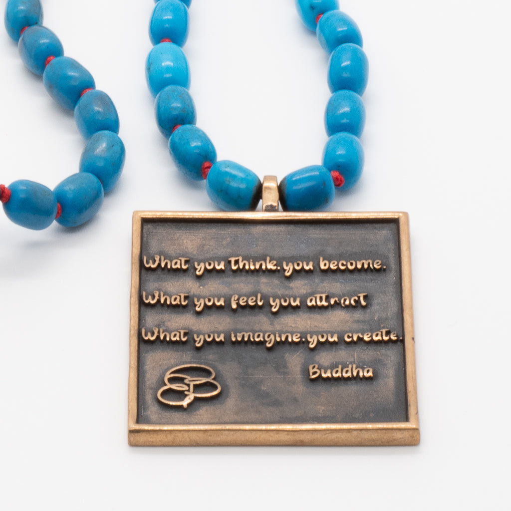 Necklace showcasing the beauty of turquoise and the spiritual symbolism of Ganesha and Buddha.