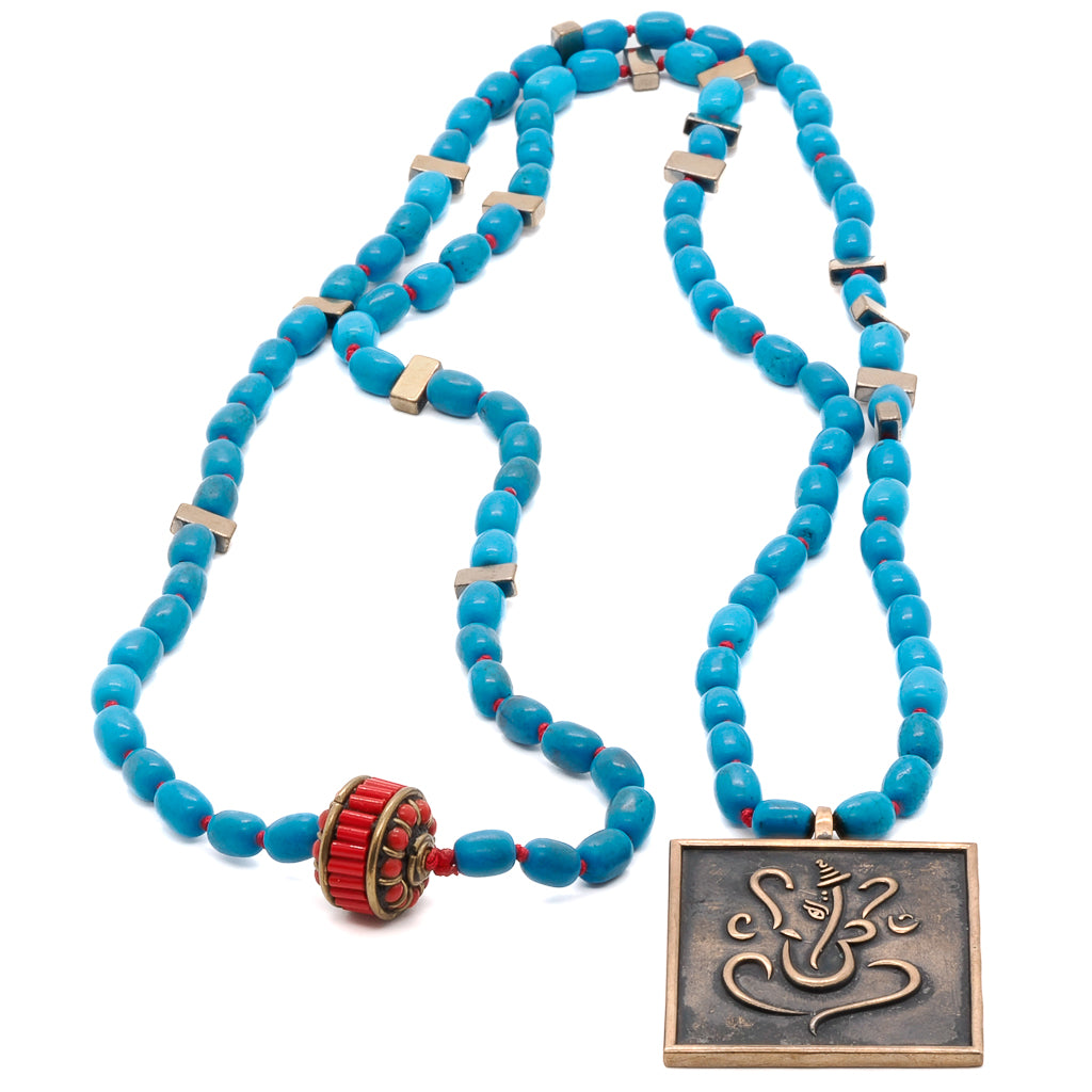 Handmade necklace featuring natural turquoise stone beads and a meaningful Ganesha and Buddha pendant.