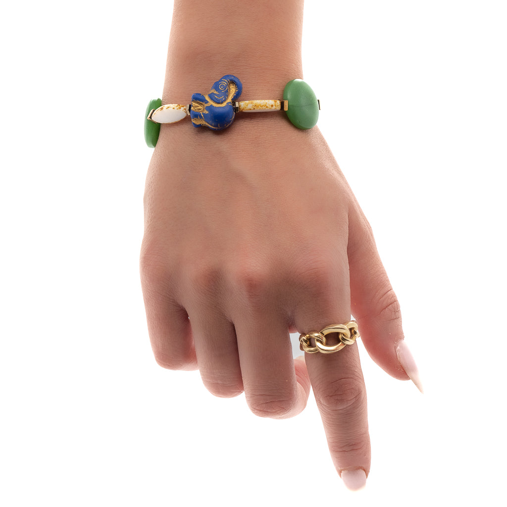 See how the Purple Elephant Bracelet adds a touch of playfulness and elegance to the hand model&#39;s ensemble.