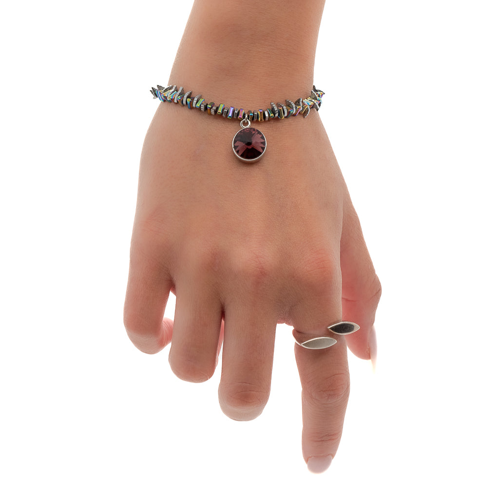 See how the Purple Magic Bracelet enhances the hand model&#39;s style with its sparkling Swarovski crystals and enchanting purple charm.
