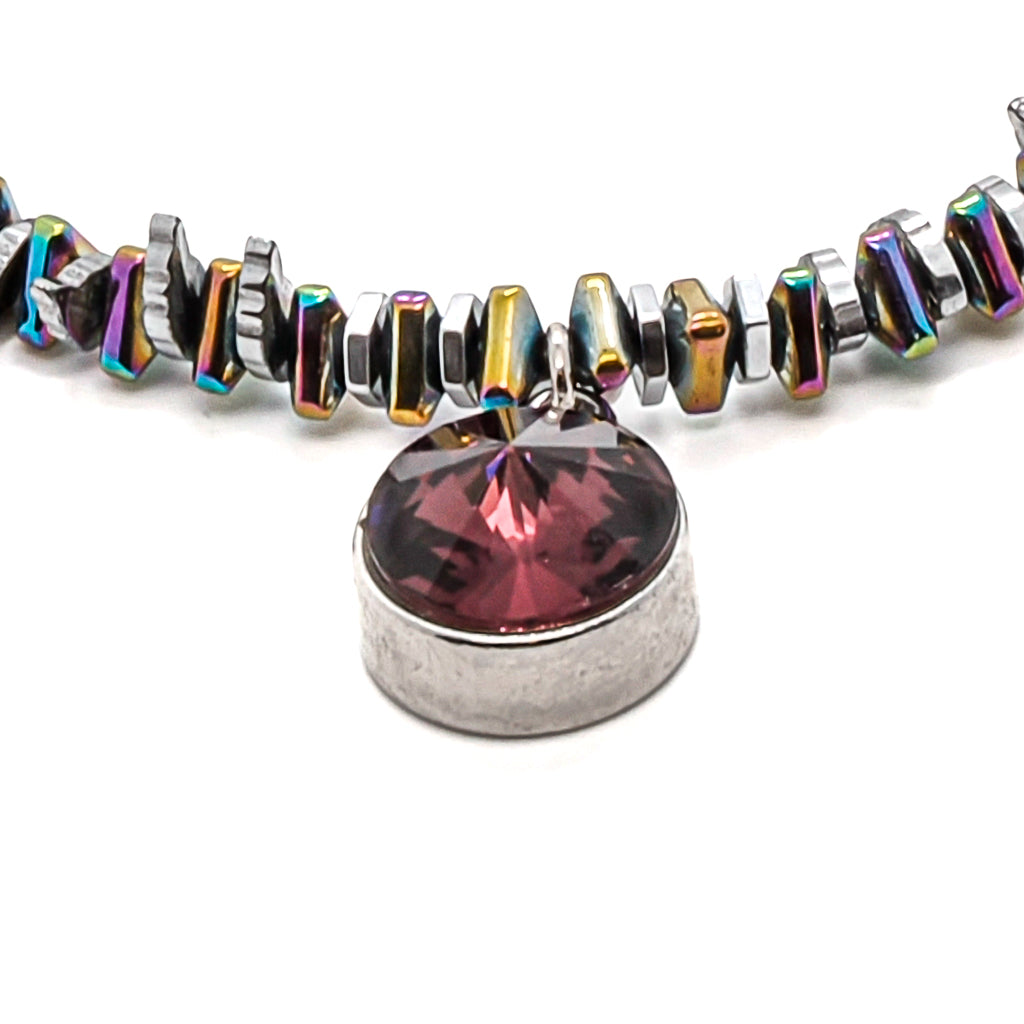 Adorn your wrist with the enchanting Purple Magic Bracelet, featuring multicolor hematite beads and a mesmerizing Swarovski charm.