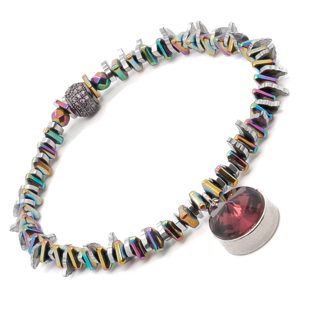 Experience the magic and beauty of the Purple Magic Bracelet, crafted with multicolor hematite stone beads and a Swarovski charm.