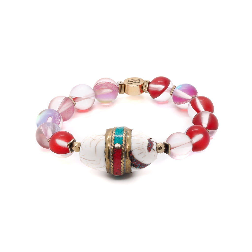 Explore the beauty of the Red Cat Eye Ethnic Bracelet, showcasing its vibrant red eye stone beads and gold-colored hematite spacers.