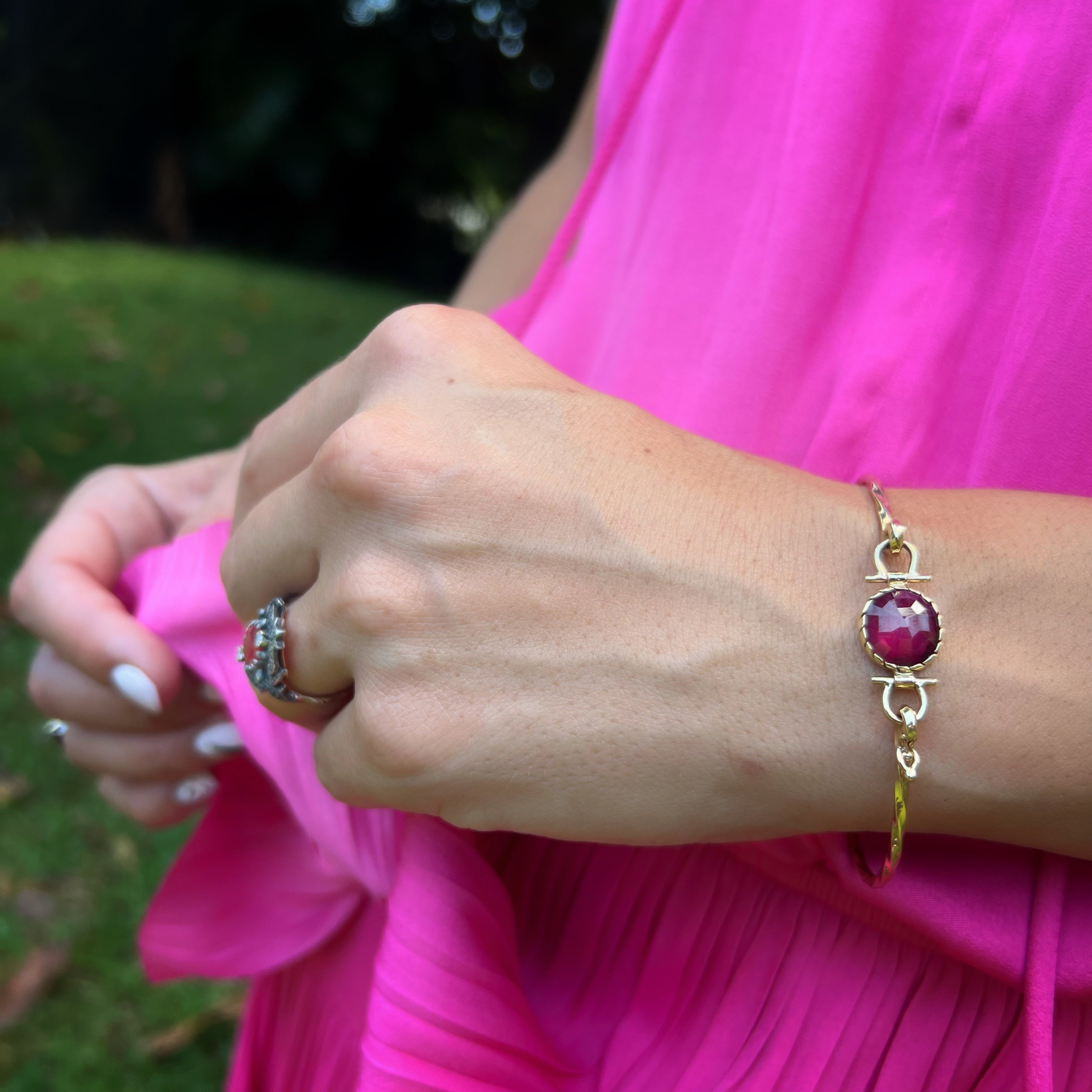 Hand Model Wearing Gold Ruby Bangle Bracelet - A hand model showcasing the elegance and sophistication of the Gold Ruby Bangle Bracelet.