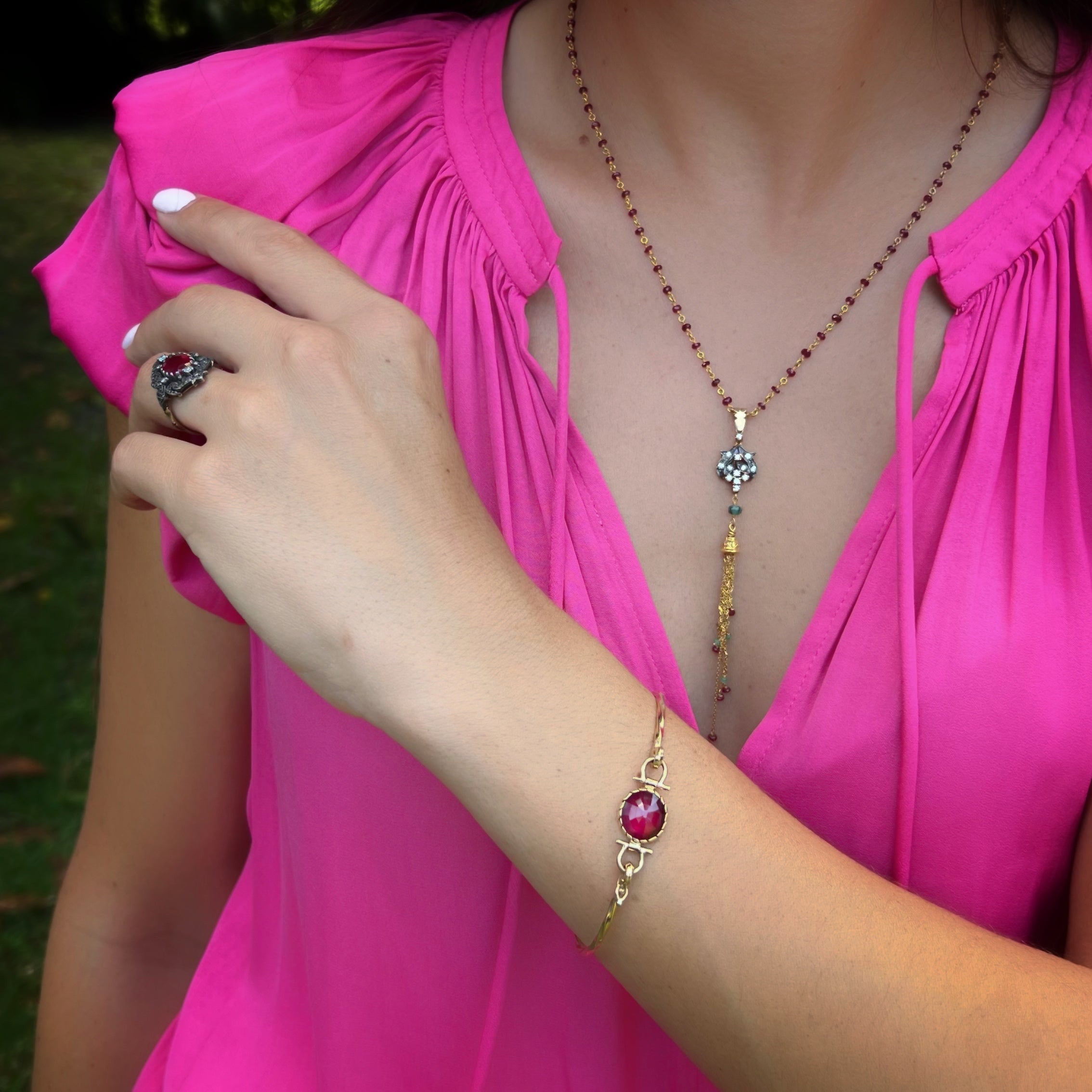 Stylish Hand Model with Gold and Ruby Bracelet - A fashionable hand model displaying the striking Gold Ruby Bangle Bracelet, adding a touch of glamour to any ensemble.