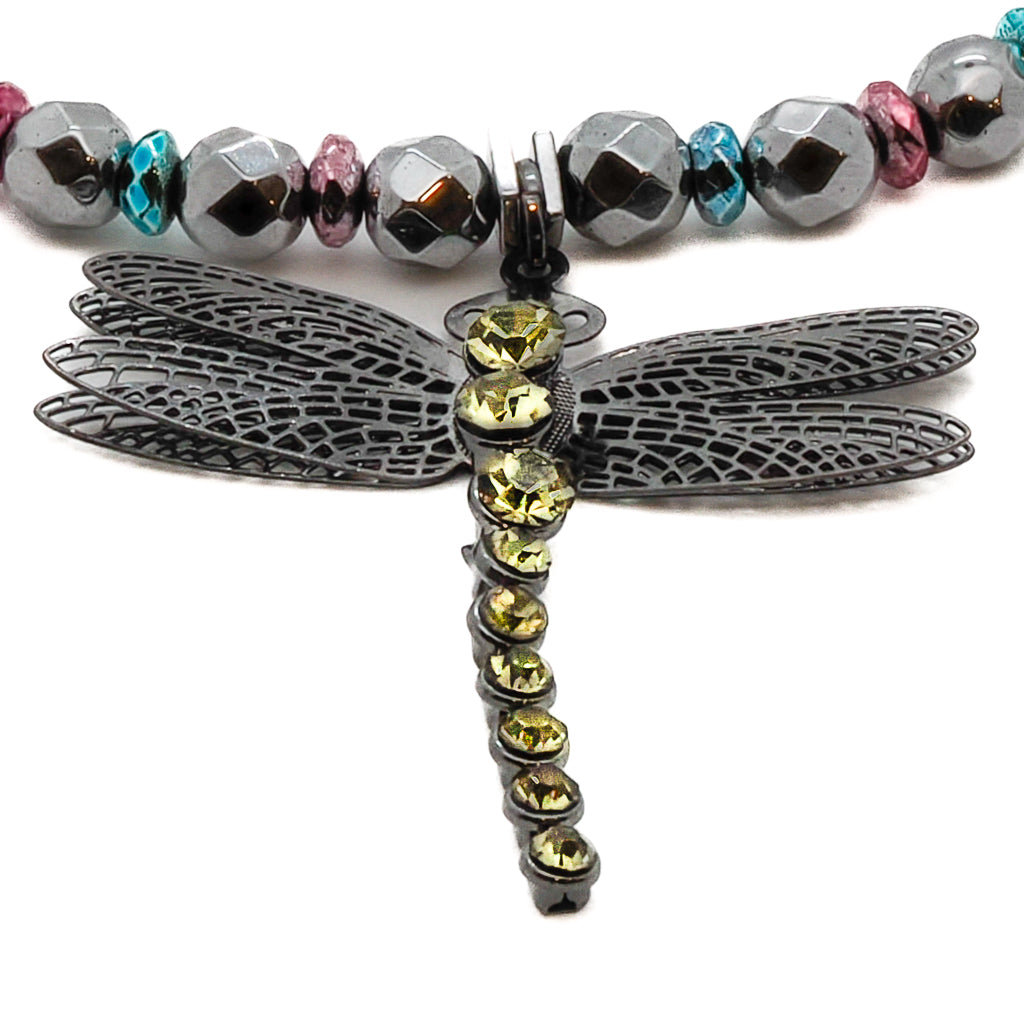 Step into a journey of self-discovery and growth with the Self Love Dragonfly Anklet, adorned with silver hematite stone beads, blue and pink hematite spacers, and a silver dragonfly charm, symbolizing transformation and embracing one&#39;s true self.