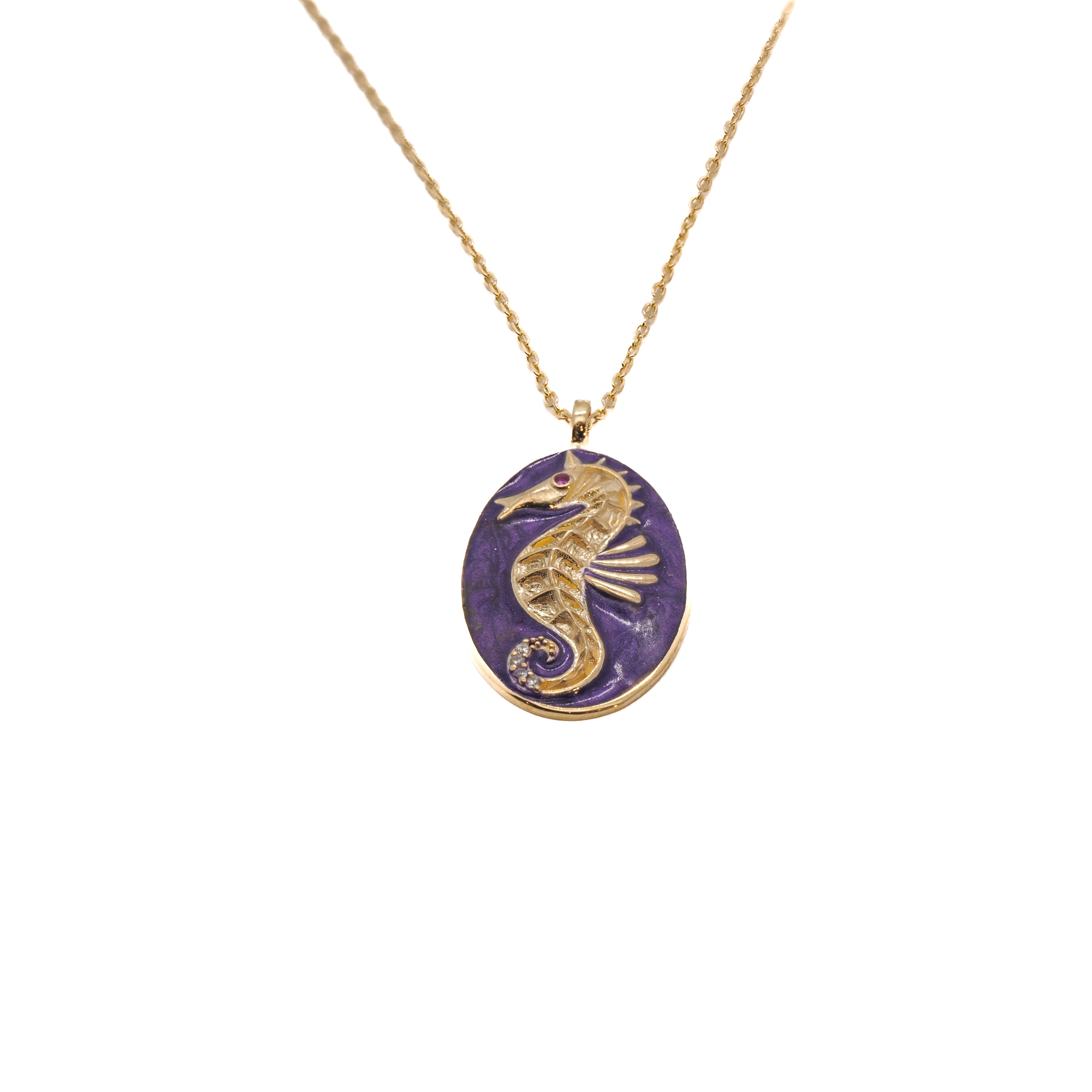 The Spirit Animal Seahorse Necklace, a captivating piece featuring an intricately detailed seahorse pendant in vibrant purple enamel.