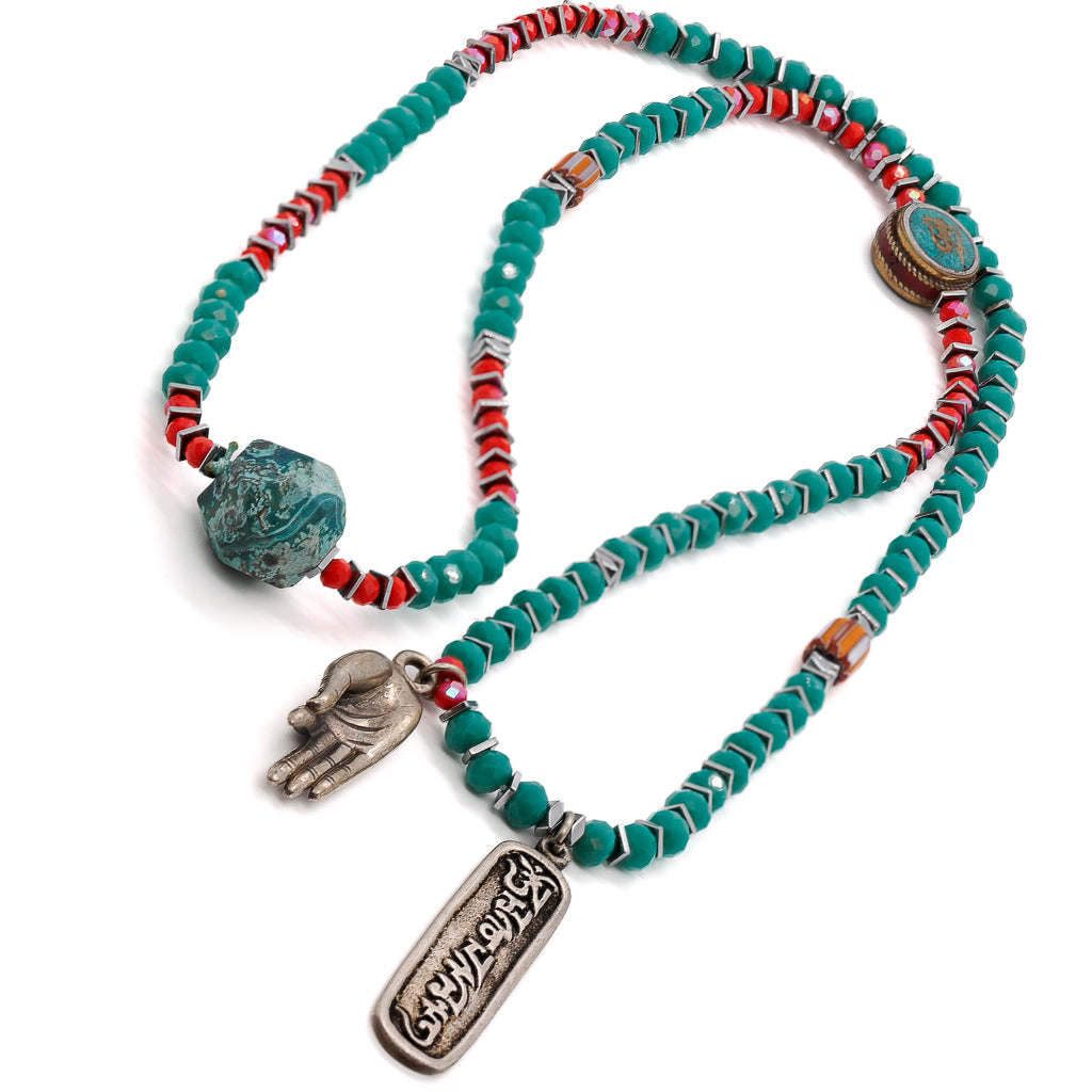 Necklace with green crystal beads and a Tibetan silver Om Mani Padme Hum pendant, perfect for spiritual practices.