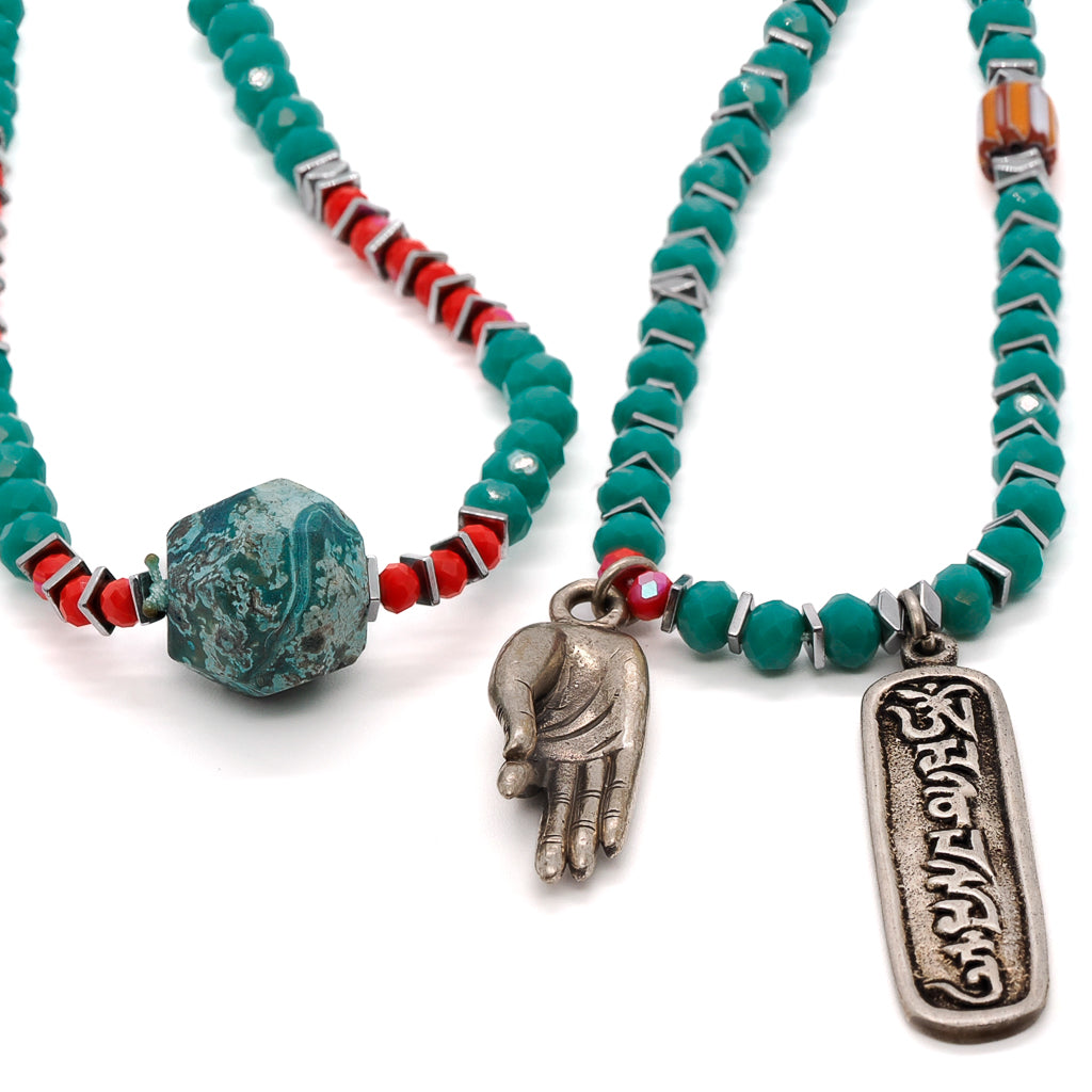 Serene Necklace featuring green crystal beads and a Tibetan silver pendant, symbolizing peace and enlightenment.