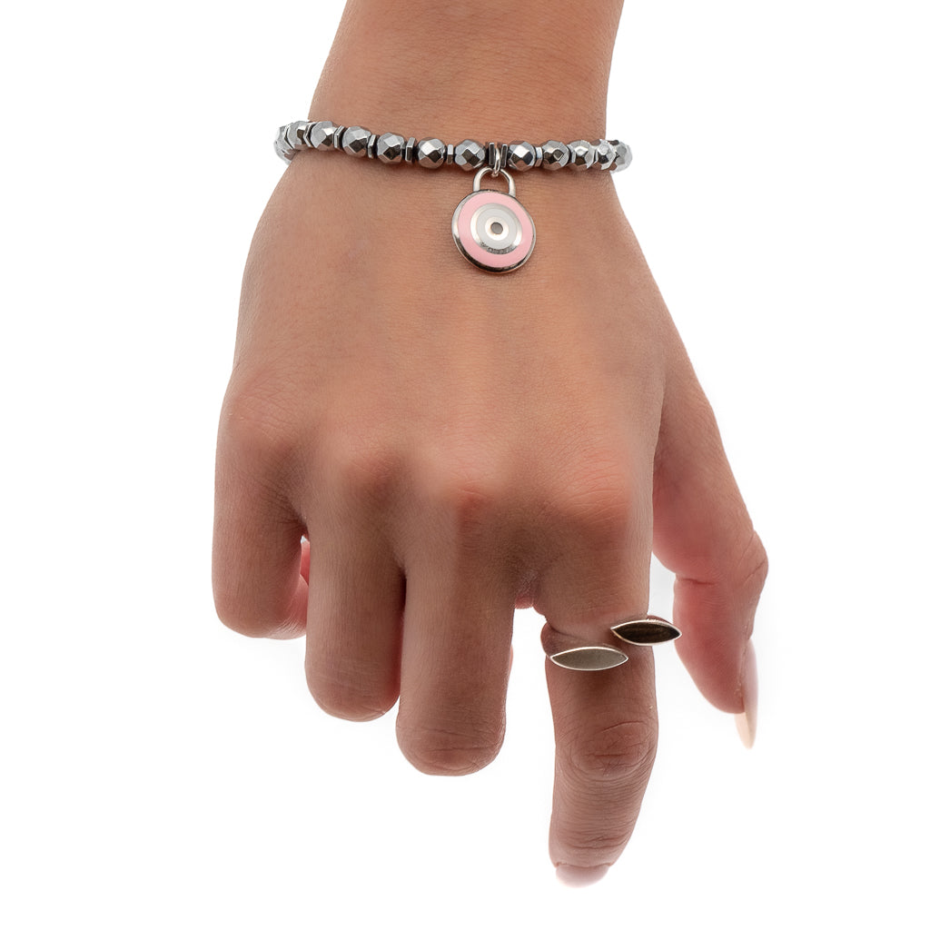 See how the Spiritual Pink Evil Eye Bracelet enhances the hand model's style with its silver hematite stone beads and Sterling silver pink enamel evil eye charm.