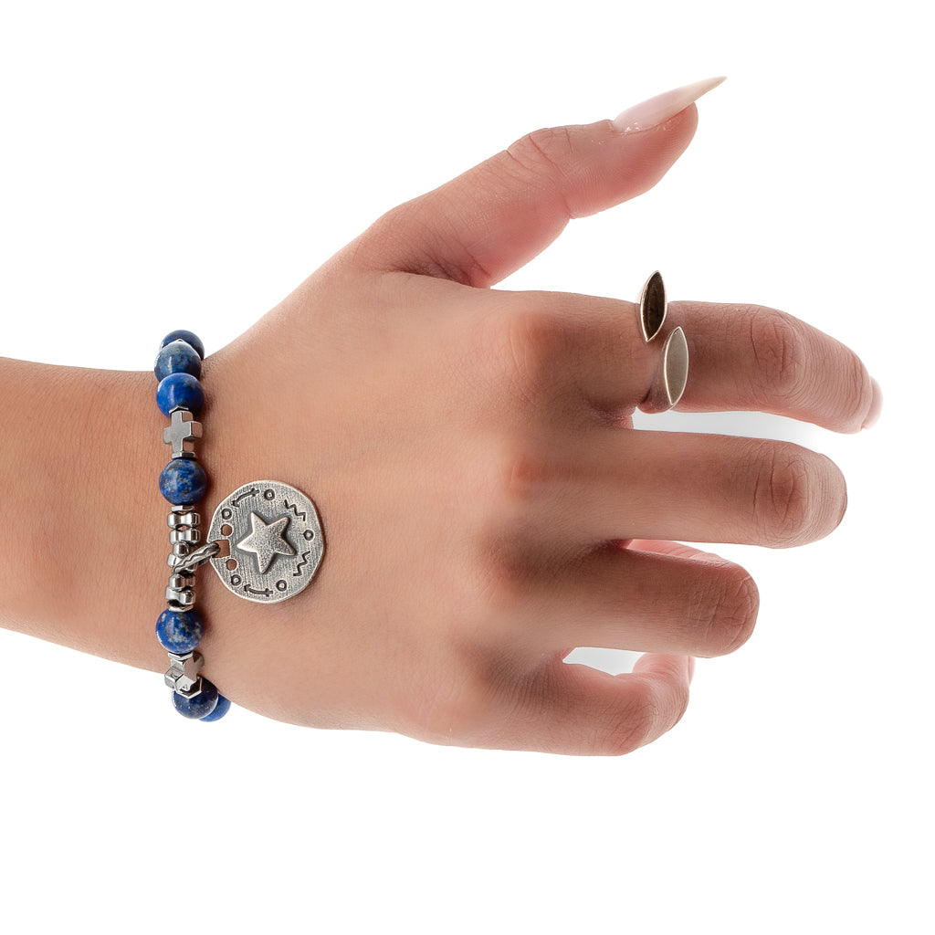 Hand model showcases the elegance and charm of the Star Blue Lapis Lazuli Bracelet, featuring lapis lazuli stone beads and a silver star charm.
