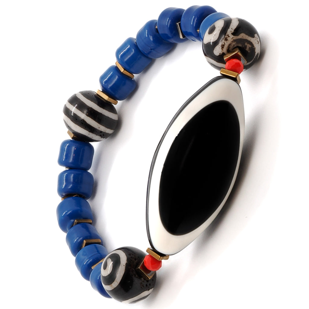 The Third Eye Tibetan Bracelet combines chunky handmade jewelry with vibrant blue Indian beads and a striking eye resin centerpiece.