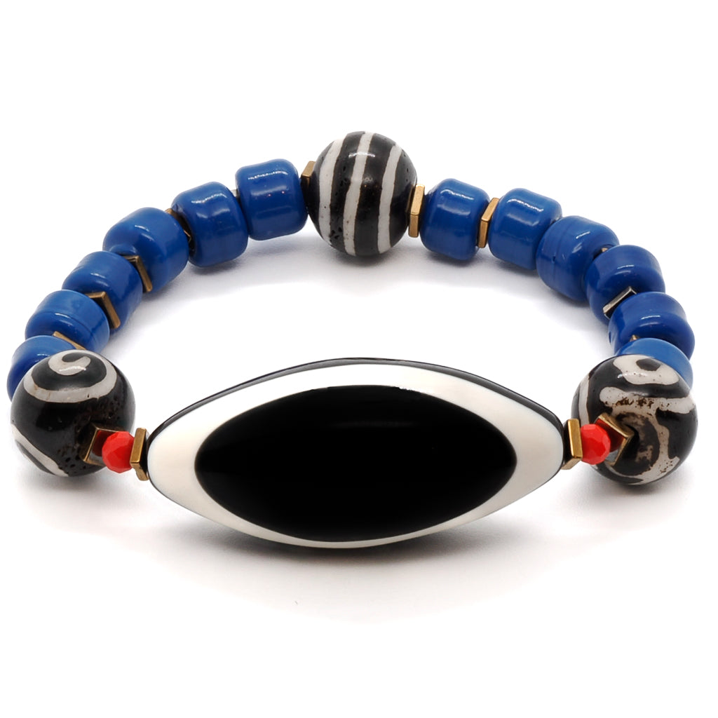 The Third Eye Tibetan Bracelet is a unique accessory that brings together vibrant blue Indian beads and a protective eye resin bead.