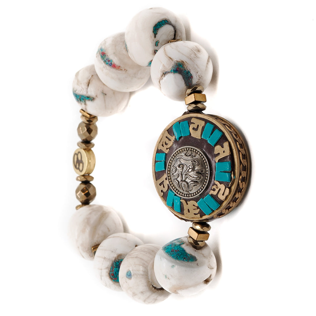 Find peace and harmony with the Tibetan Mantra Bracelet, adorned with Nepalese White beads and a symbolic Om Mani Padme Hum mantra disc bead.