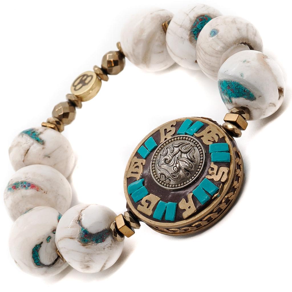 Find inner peace and connection with the universe with the Tibetan Mantra Bracelet, adorned with Nepalese White beads and a sacred Om Mani Padme Hum mantra disc bead.