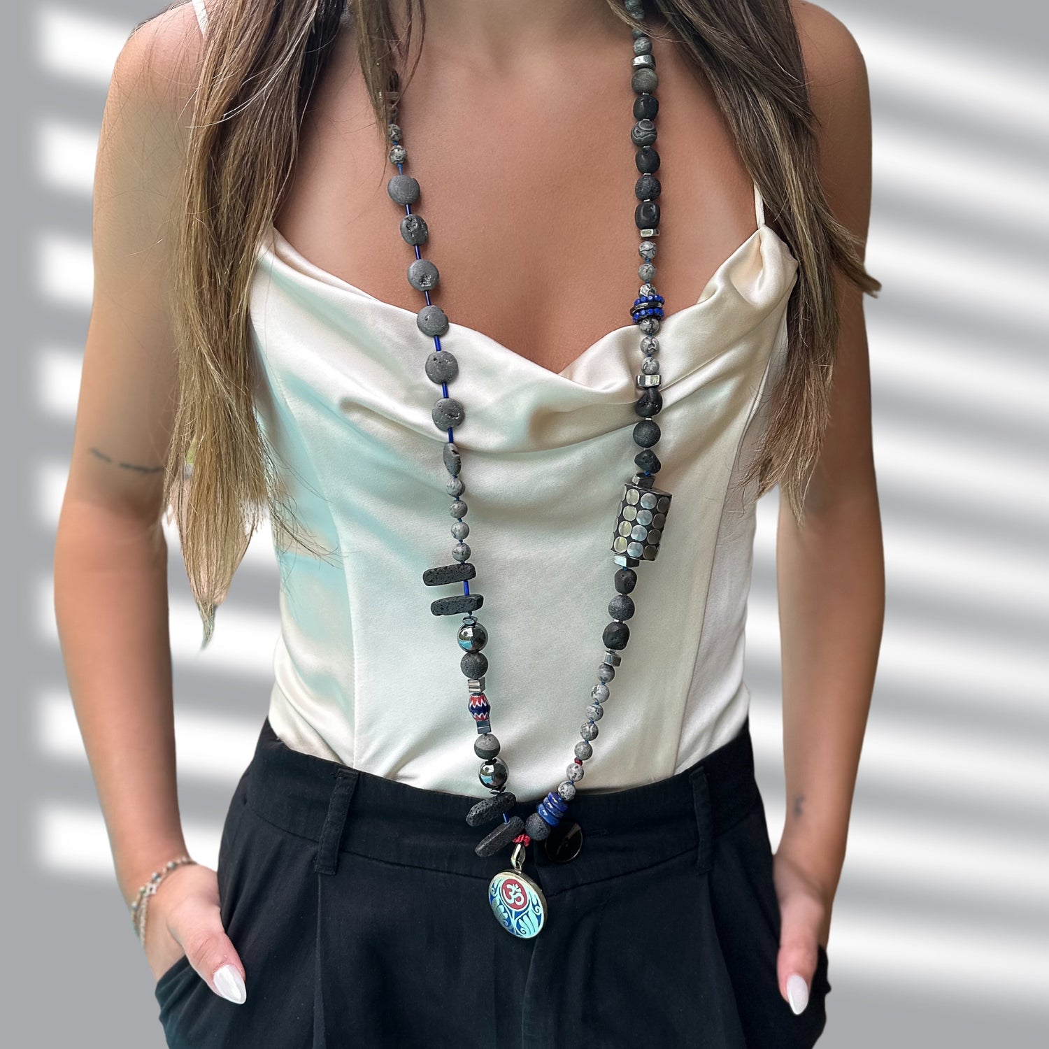 The model showcases the timeless elegance of the Tibetan Om Necklace, radiating a sense of inner peace and style.