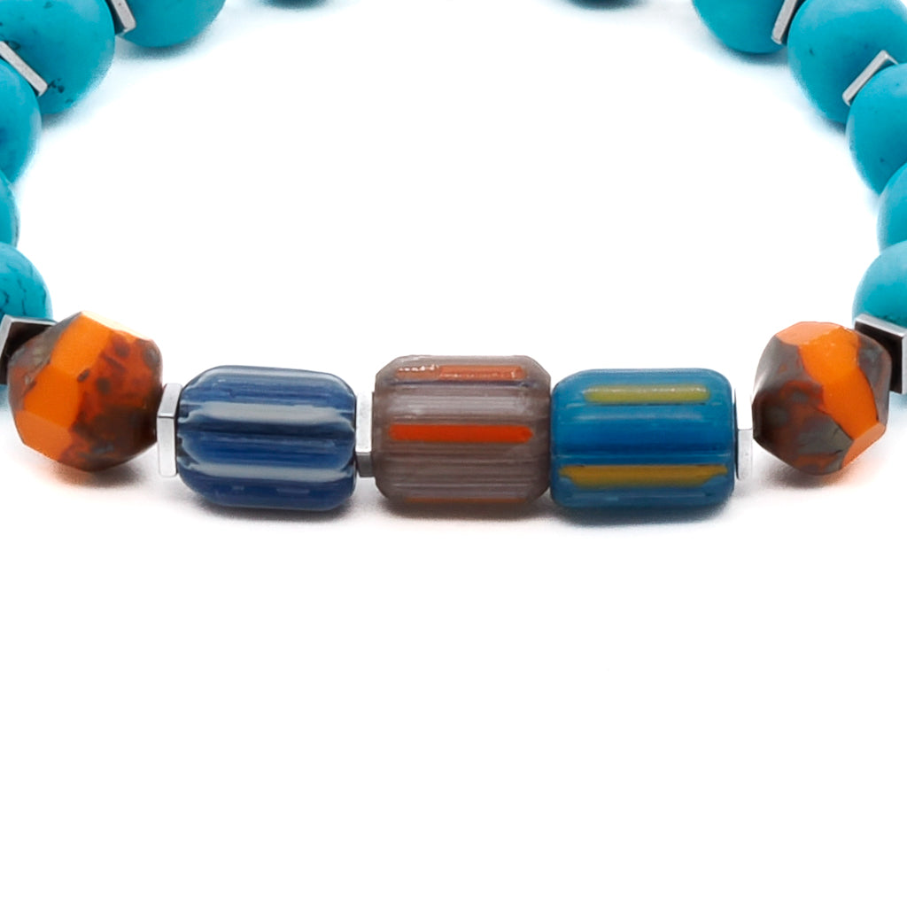 Discover the allure of the Tropical Vibes Evil Eye Bracelet, showcasing the vibrant turquoise stone beads, colorful African beads, and a silver evil eye bead.