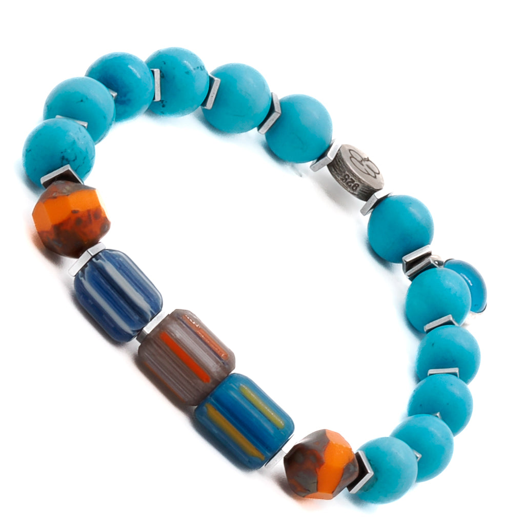 Experience the striking design of the Tropical Vibes Evil Eye Bracelet, showcasing turquoise stone beads, colorful African beads, and a silver evil eye bead.