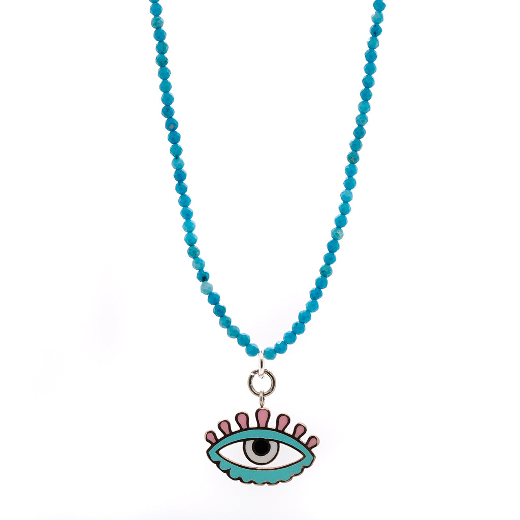 The combination of the turquoise beads and the enamel Evil Eye pendant creates a stunning contrast that is both eye-catching and elegant.