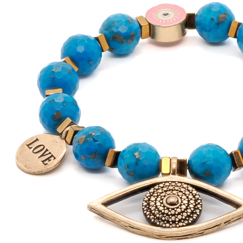 Adorn your wrist with the Turquoise Love Bracelet, showcasing its stunning turquoise stone and bronze evil eye charm.