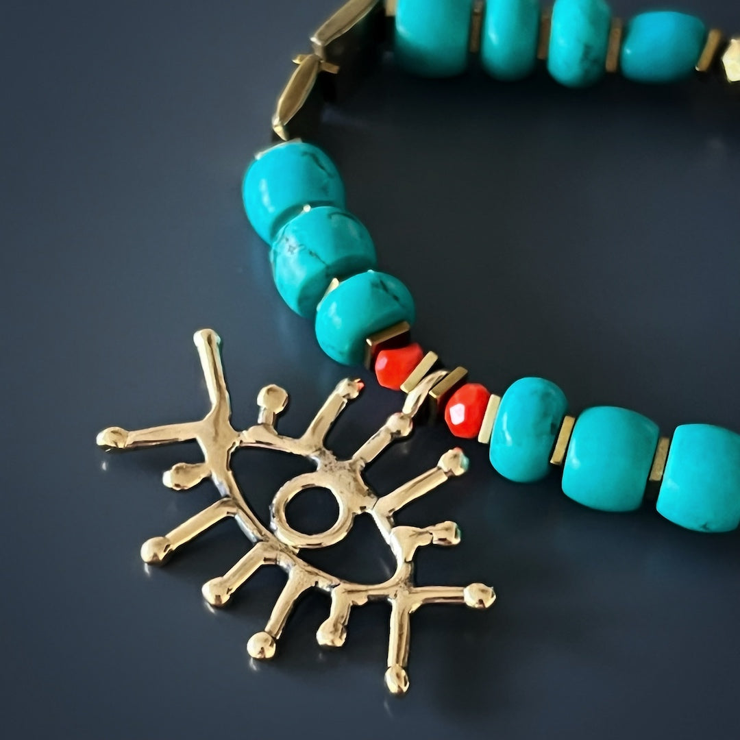 Radiate elegance and spiritual energy with the Turquoise Long Lash Bracelet, showcasing the captivating allure of turquoise beads, a sparkling Swarovski crystal, hematite, and a brass evil eye charm.