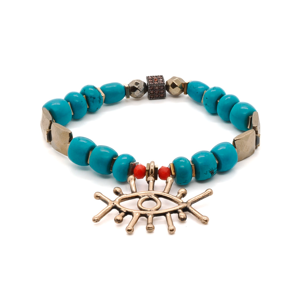 Embrace the elegance of the Turquoise Long Lash Bracelet, adorned with turquoise beads, a sparkling Swarovski crystal, and a brass evil eye charm.