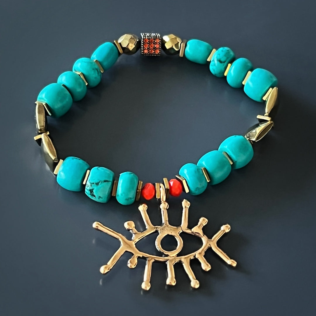 Enhance your style and protection with the Turquoise Long Lash Bracelet, adorned with turquoise beads, a Swarovski crystal, hematite, and a captivating brass evil eye charm.