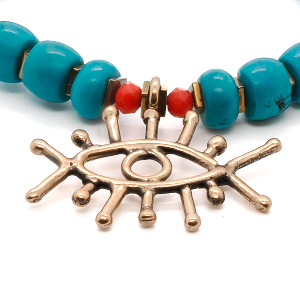 Discover the balancing and purifying properties of the Turquoise Long Lash Bracelet, adorned with turquoise beads, a Swarovski crystal, hematite, and a brass evil eye charm.
