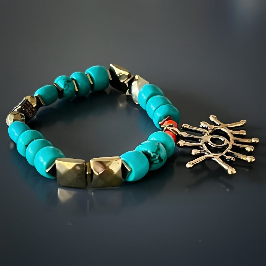 The Turquoise Long Lash Bracelet embodies elegance and spiritual energy, combining turquoise beads, a sparkling Swarovski crystal, hematite, and a protective brass evil eye charm.