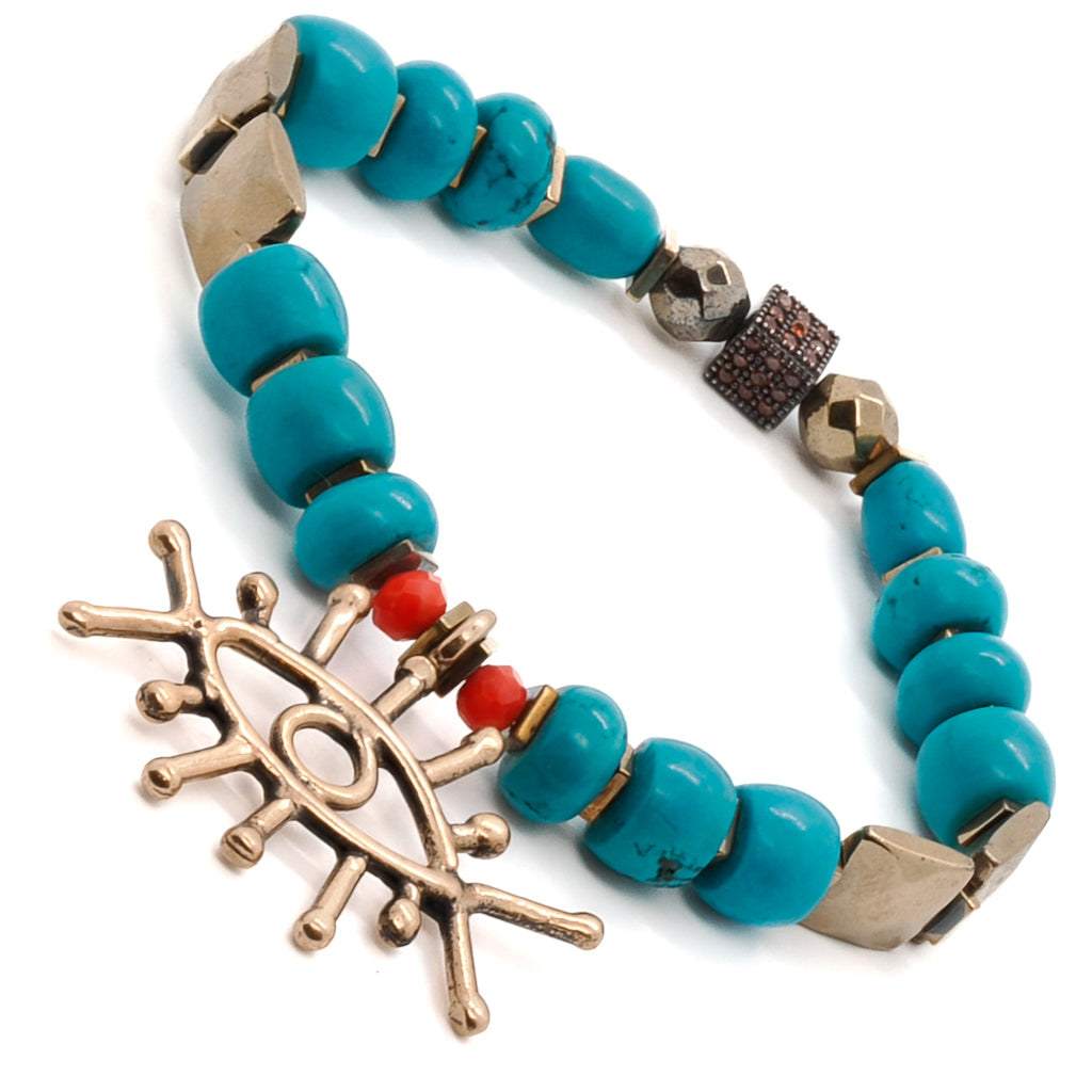 Experience the spiritual energy and protection of the Turquoise Long Lash Bracelet, featuring turquoise beads, hematite, and a captivating brass evil eye charm.