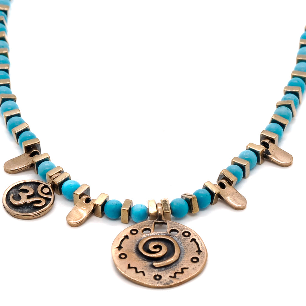 Turquoise Spiral Necklace featuring a combination of turquoise and hematite stone beads with gold spacers.