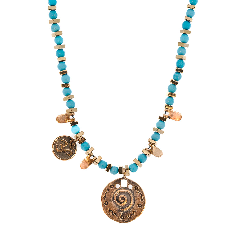 Elegant necklace featuring the vibrant turquoise stone beads and gold hematite spacers, with the OM mantra charm.