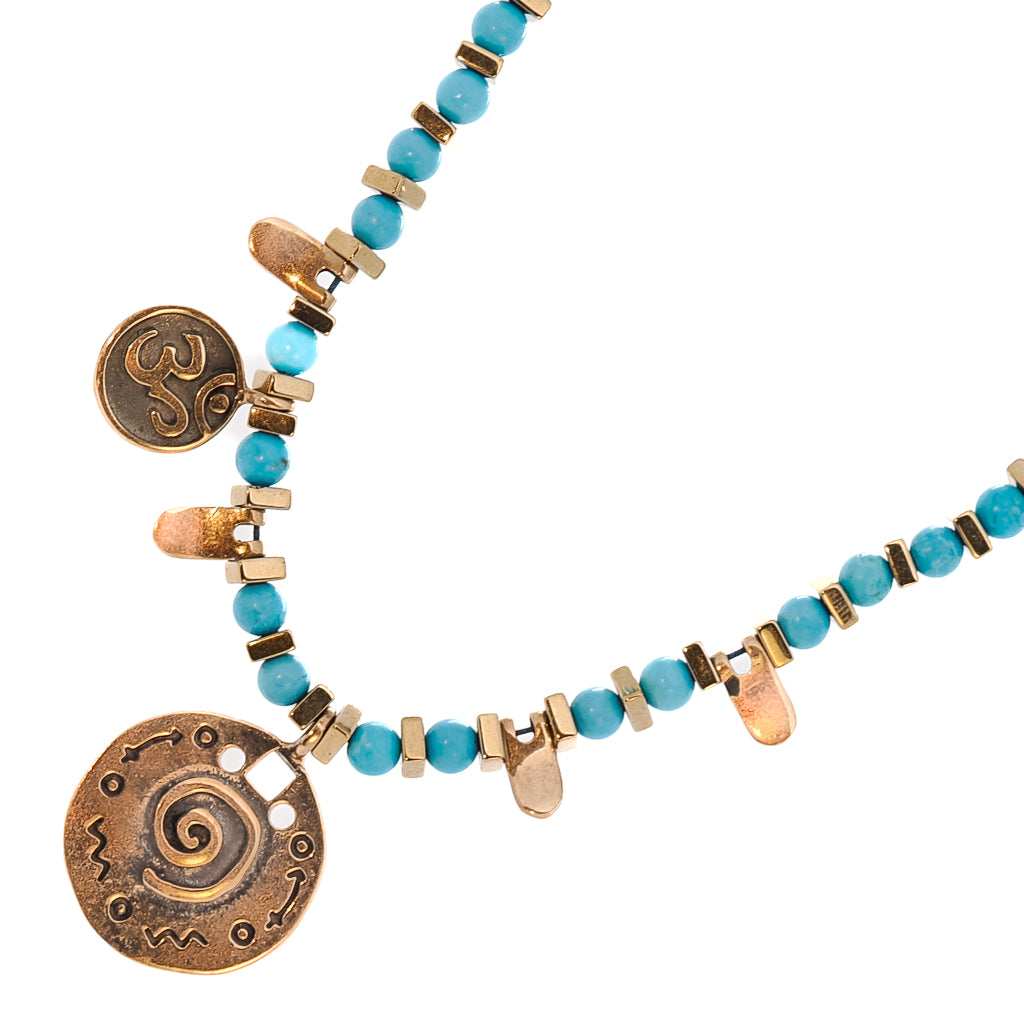 Turquoise Spiral Necklace featuring a combination of turquoise and hematite stone beads with gold spacers.