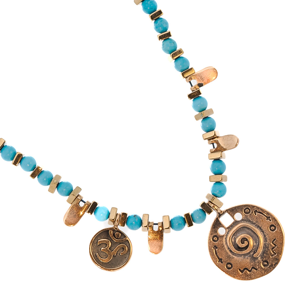 Handmade Turquoise Spiral Necklace showcasing the calming energy of the turquoise stones and the intricate spiral charm.