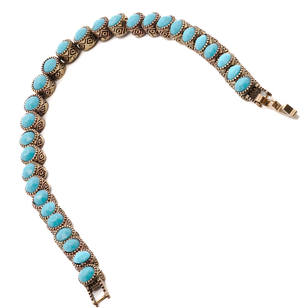 A close-up of the bronze tennis bracelet with beautiful turquoise stones.