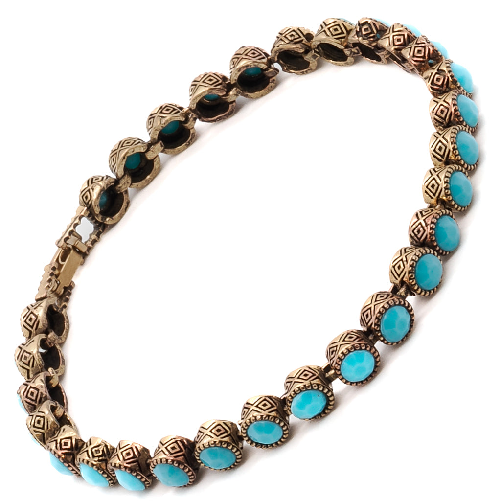 The turquoise crystal stones on the simple and elegant bronze tennis bracelet.