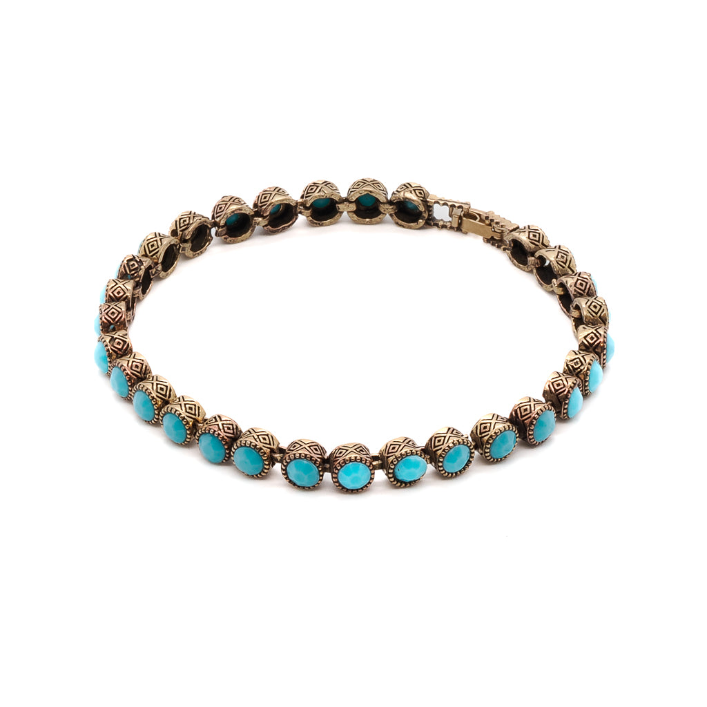 The Turquoise Tennis Bracelet, a handmade bronze bracelet adorned with turquoise crystal stones.