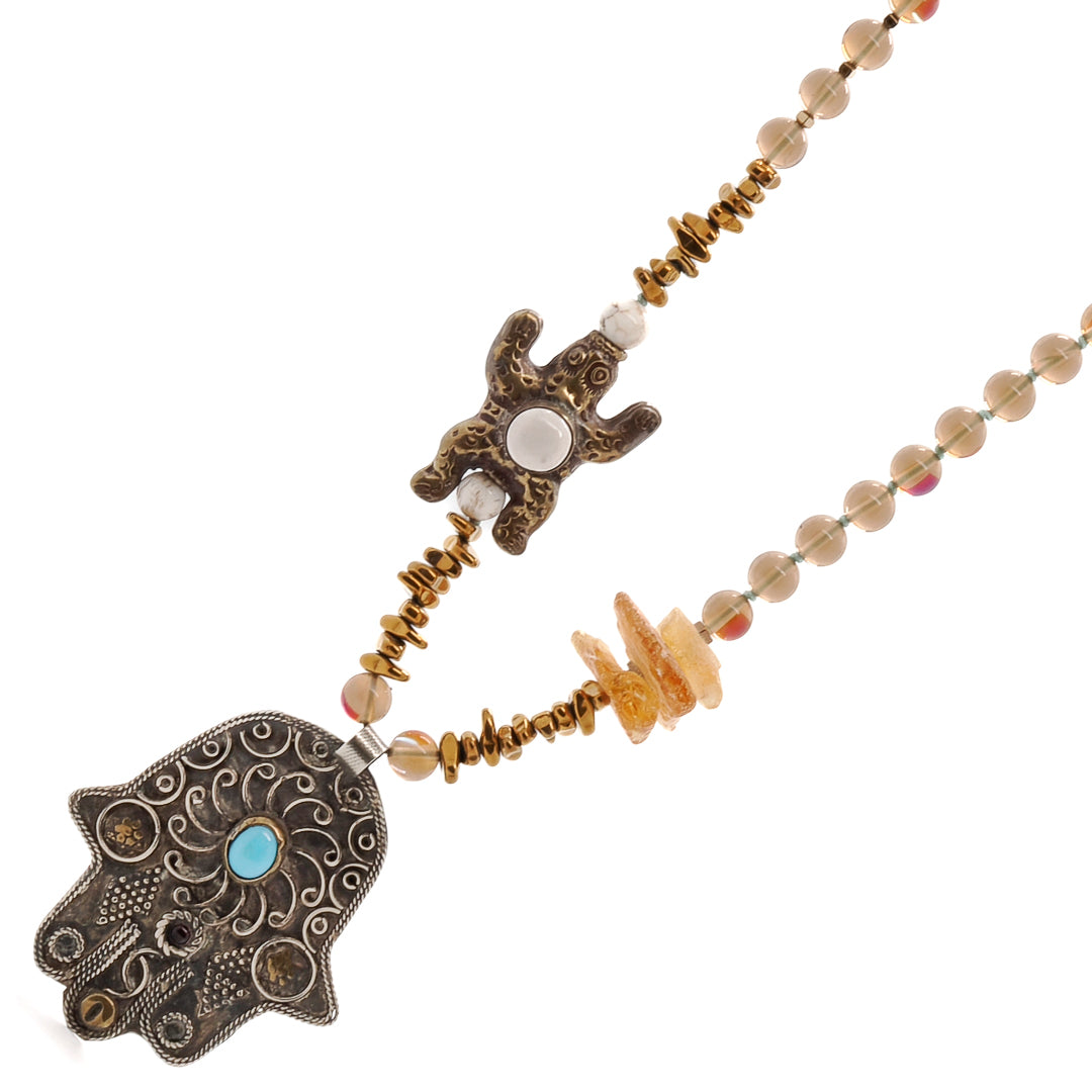 Experience the charm of the Turtle Necklace, featuring amber and hematite beads for an eye-catching look.