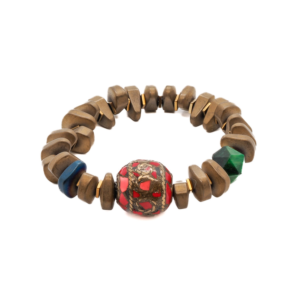 Discover the beauty of the Vintage Nepal Bracelet, featuring matte gold hematite nugget beads and a striking red and gold Nepal bead.