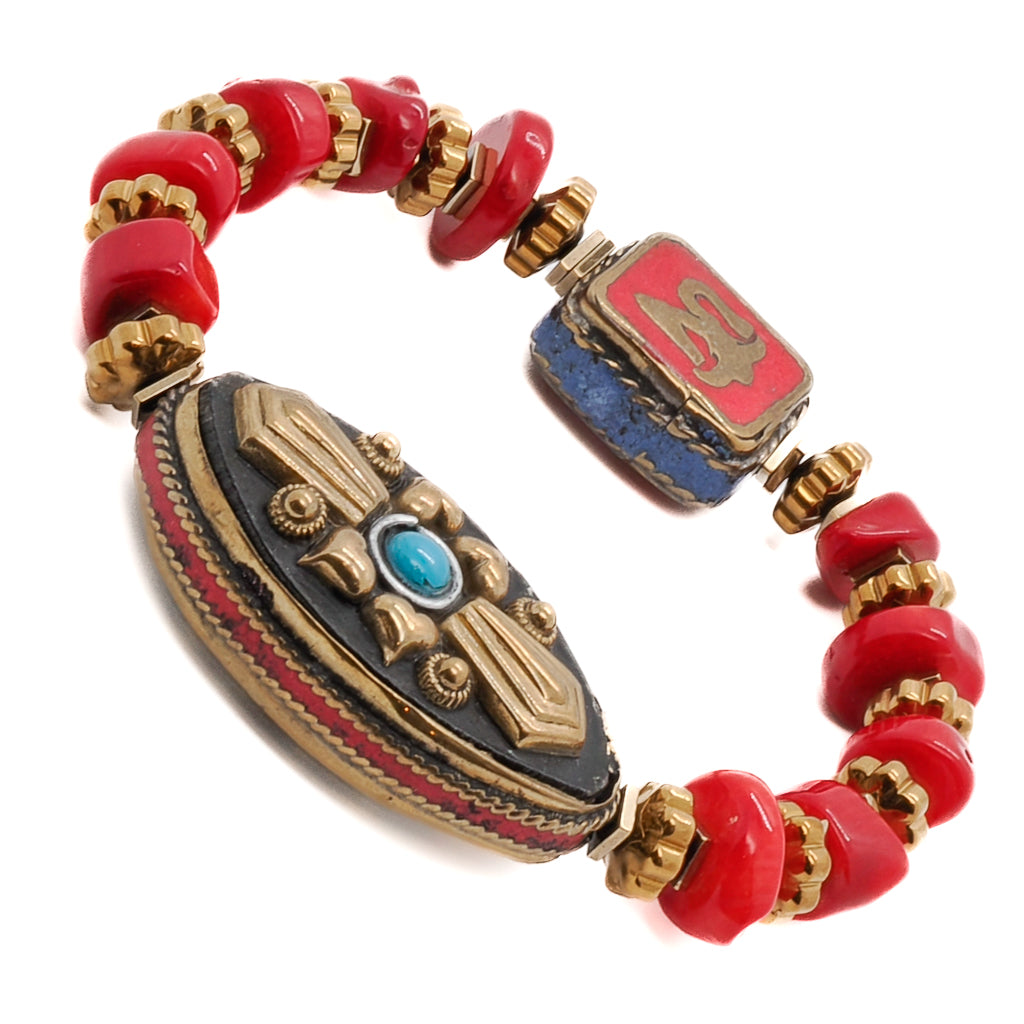 Embrace the bohemian charm of the Vintage Style Ethnic Om Bracelet, a handmade piece with a Nepal-inspired charm and red coral beads.