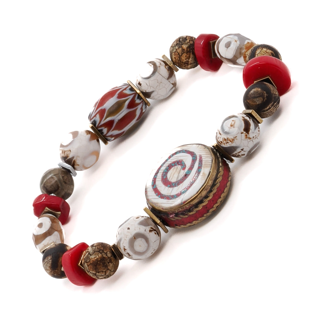Enhance your spiritual practice with the Yoga Spirit Mystic Bracelet, adorned with coral stone beads, Nepal meditation beads, and a spiral charm.