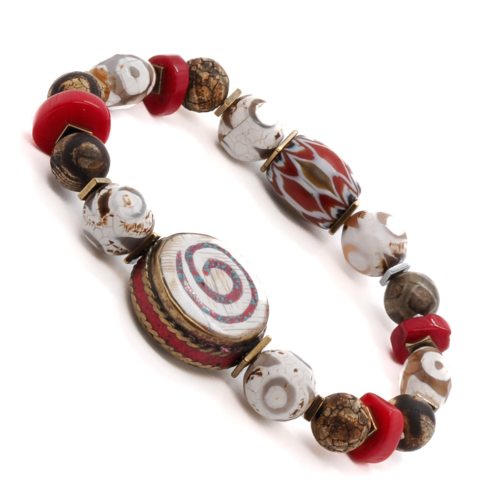 Elevate your style with the Yoga Spirit Mystic Bracelet, showcasing the vibrant energy of rondella coral stone beads, Nepal meditation beads, and a stunning spiral charm.