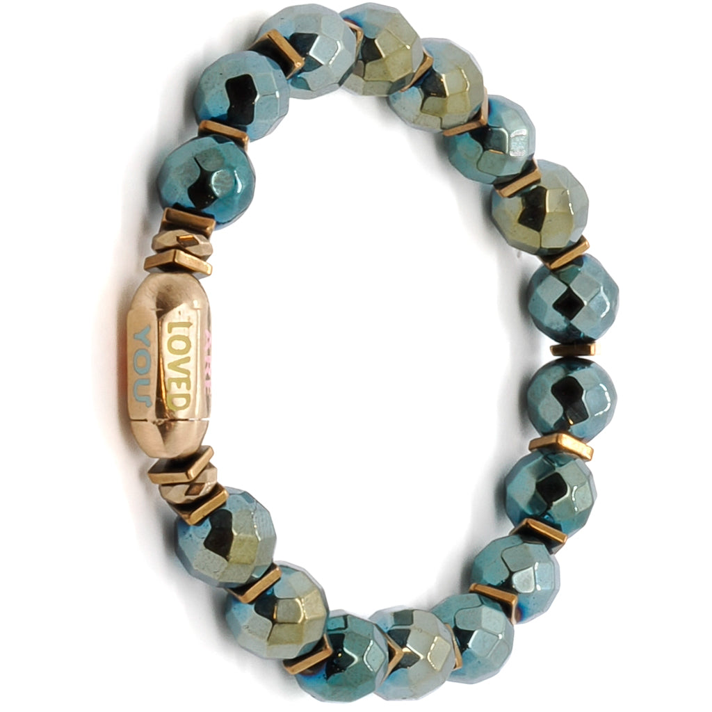 The You Are Loved Bracelet serves as a constant reminder of love and support, featuring green hematite stone beads and a meaningful &quot;You Are Loved&quot; tube bead.