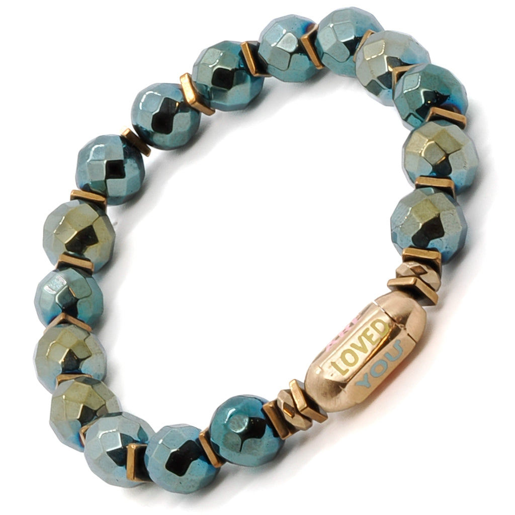 Find tranquility and appreciation with the You Are Loved Bracelet, showcasing green hematite stone beads and a meaningful "You Are Loved" tube bead.