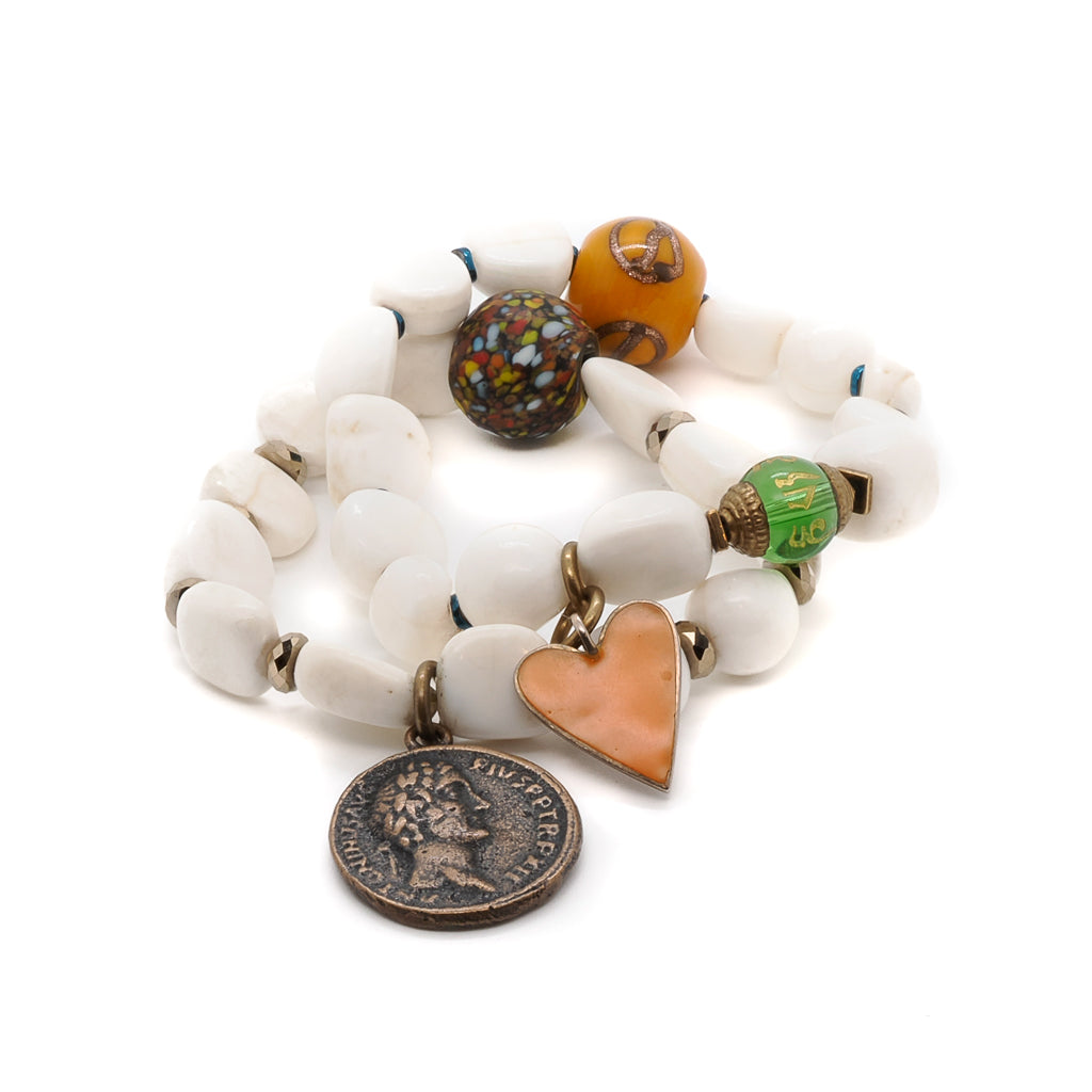 Discover the serenity of the Zen Bracelet Set, featuring Tibetan White Stone Beads, a green glass Om Mani Padme Hum bead, and a bronze elephant charm.